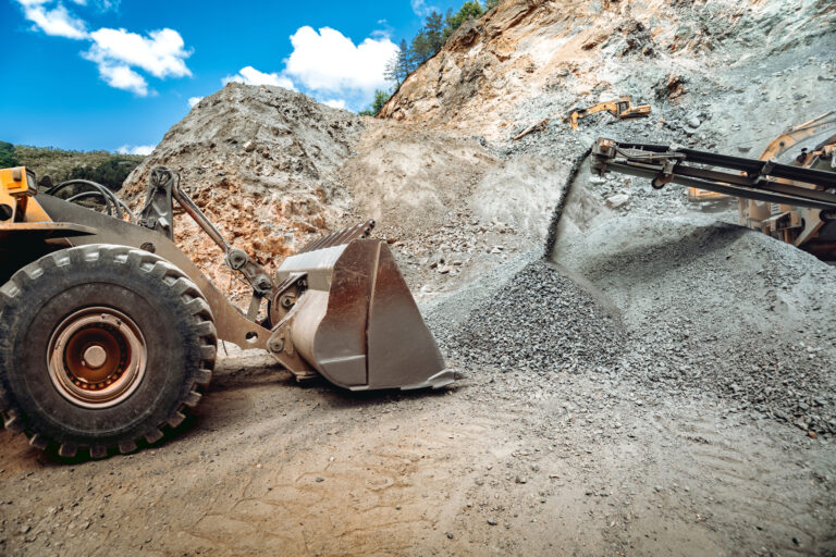 mining-industry-industrial-vehicles-on-constructi-2021-08-28-18-45-57-utc-768×512 Heavy duty wheel loader excavator working in ore quarry. Mining industry. Industrial vehicles on construction site