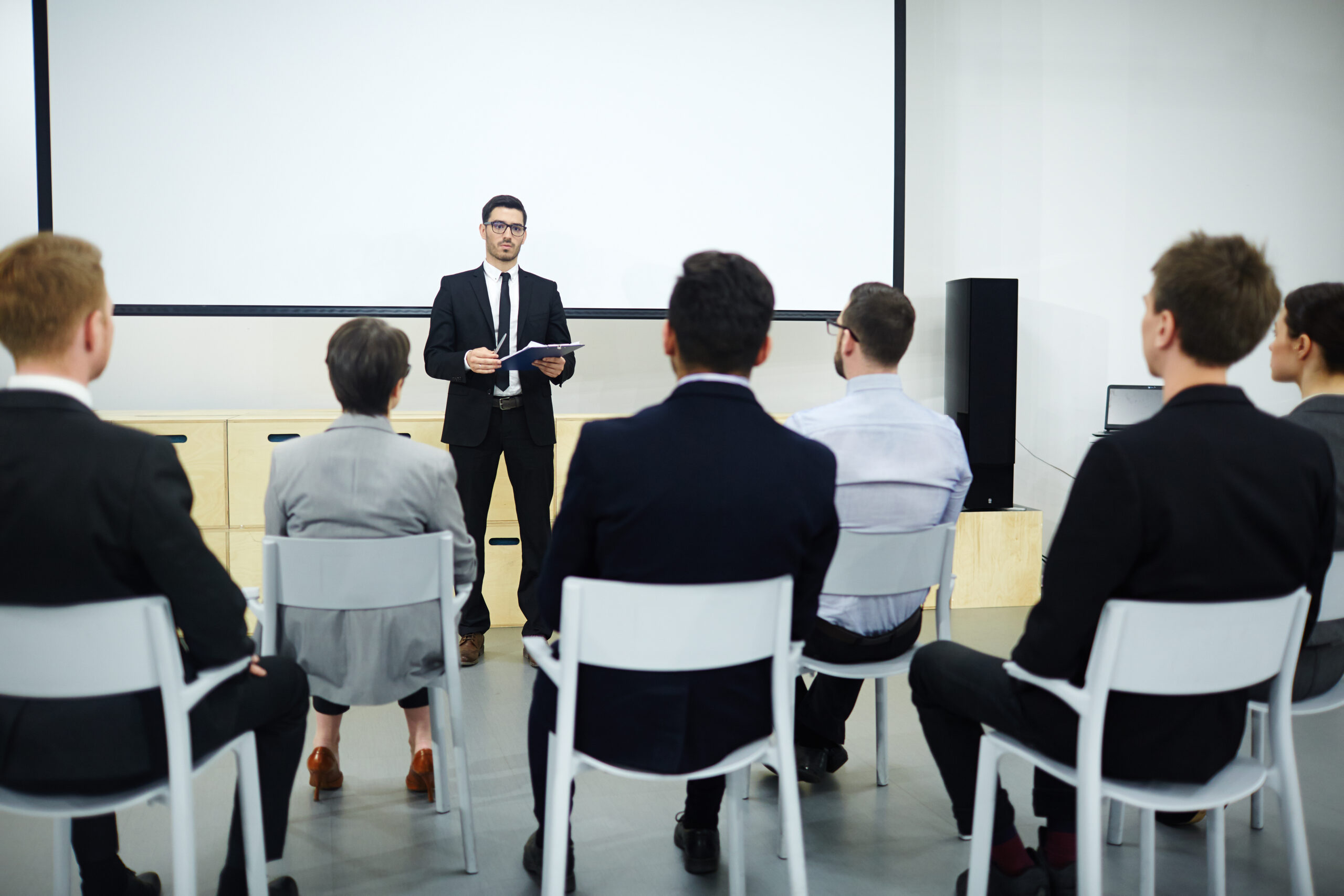 Qualification training Rear view of audience listening to speech of successful business professional